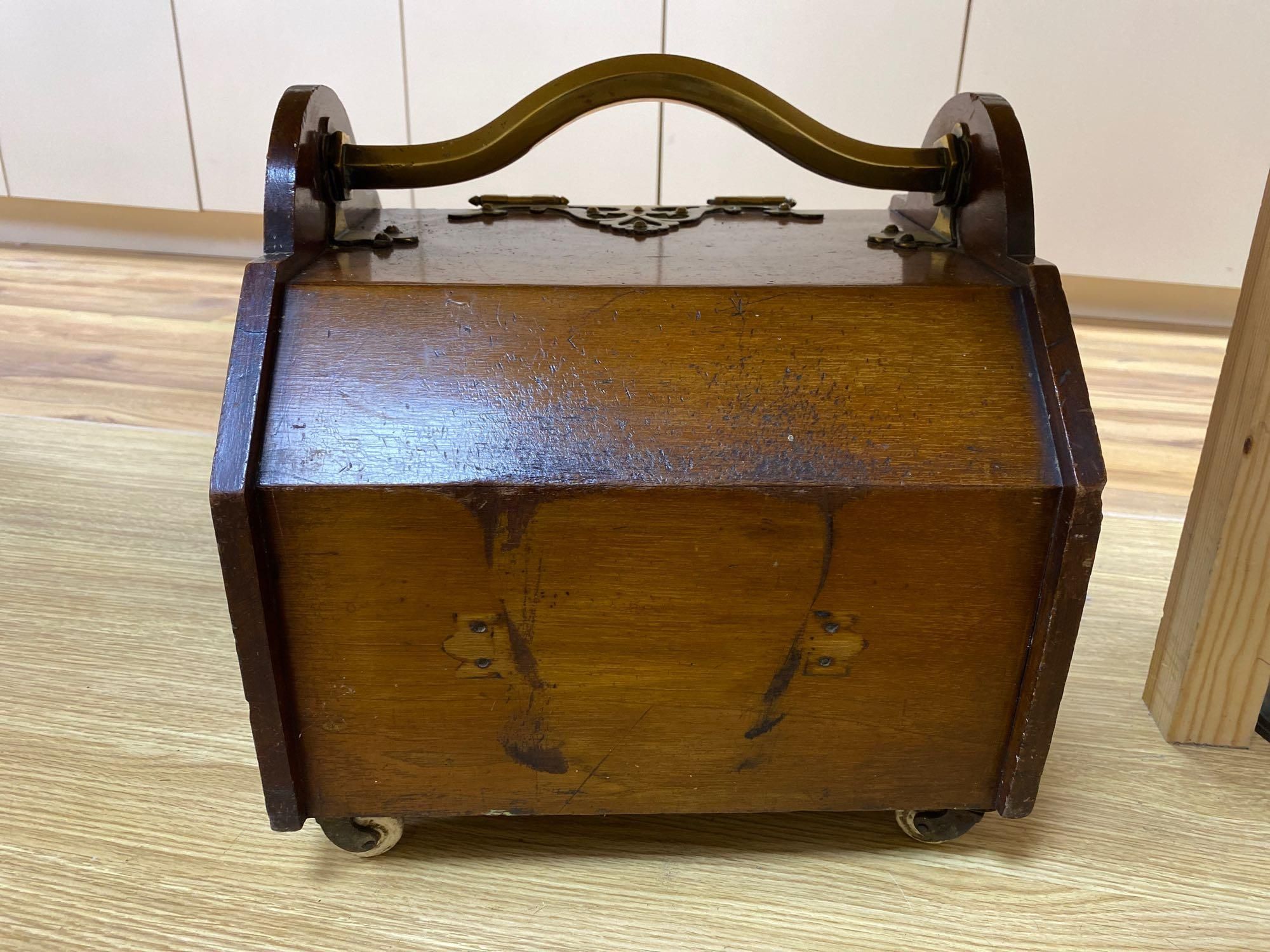 A Gothic revival walnut and brass mounted coal box on ceramic casters, 35cm wide